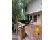 A wood porch with outdoor furniture and multiple windows with view of backyard forest at 974 Bloomfield Dr, Lawrenceville, GA 30044