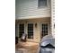 A wood porch with lounge chairs, grill, and multiple windows on the rear of the home at 974 Bloomfield Dr, Lawrenceville, GA 30044