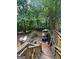 Multi-level deck in a wooded backyard with outdoor seating and forest views at 974 Bloomfield Dr, Lawrenceville, GA 30044