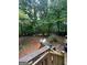 Multi-level deck in a wooded backyard with outdoor seating and greenery at 974 Bloomfield Dr, Lawrenceville, GA 30044