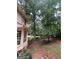 Exterior shot of home with fenced yard and view to trees at 974 Bloomfield Dr, Lawrenceville, GA 30044