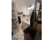 Bright bathroom featuring a single sink vanity, mirrored medicine cabinet, and unique patterned floors at 974 Bloomfield Dr, Lawrenceville, GA 30044