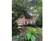 Charming brick home with lush landscaping, blue shutters, and a welcoming front entrance at 974 Bloomfield Dr, Lawrenceville, GA 30044