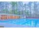 Large swimming pool with lounge chairs and a covered seating area, perfect for outdoor relaxation at 974 Bloomfield Dr, Lawrenceville, GA 30044