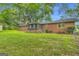 Spacious backyard featuring a classic brick house and an inviting screened porch at 1189 E Fayetteville Rd, Riverdale, GA 30296