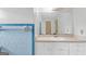 Bathroom features a tile backsplash, large mirror, and a vanity with ample storage at 1189 E Fayetteville Rd, Riverdale, GA 30296