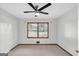 Comfortable bedroom featuring a ceiling fan, carpet, and a large window providing natural light and a pleasant view at 1189 E Fayetteville Rd, Riverdale, GA 30296