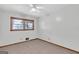 A bedroom features a window bringing in natural light and ceiling fan at 1189 E Fayetteville Rd, Riverdale, GA 30296