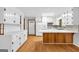 Bright kitchen with white cabinets, hardwood floors, a breakfast bar, and ample storage space for all your culinary needs at 1189 E Fayetteville Rd, Riverdale, GA 30296