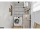 Laundry room features a washer and dryer, water heater, and shelving at 1189 E Fayetteville Rd, Riverdale, GA 30296