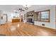 Spacious living room featuring hardwood floors, stone fireplace, and natural light, creating a warm and inviting atmosphere at 1189 E Fayetteville Rd, Riverdale, GA 30296