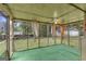 View of enclosed porch with ceiling fan and views of yard at 1189 E Fayetteville Rd, Riverdale, GA 30296