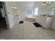 Bright bathroom featuring dual vanities, tiled floors, and a soaking tub at 176 Fairoaks Cir, Stockbridge, GA 30281