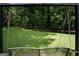 View of the sprawling backyard and mature trees from the suspended porch swing at 3359 Villa Ln, Douglasville, GA 30135