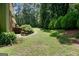 Beautiful backyard with a winding walkway, lush greenery, and tranquil setting at 3359 Villa Ln, Douglasville, GA 30135