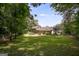 Expansive backyard featuring lush greenery and a charming home exterior, framed by mature trees at 3359 Villa Ln, Douglasville, GA 30135