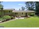 Landscaped backyard with mature trees, a patio area, and a lush lawn at 3359 Villa Ln, Douglasville, GA 30135