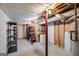 Unfinished basement with exposed ceiling, storage shelves, and utility access at 3359 Villa Ln, Douglasville, GA 30135