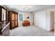 Bedroom with large closet, armoire, gray carpet, and a view into the hallway at 3359 Villa Ln, Douglasville, GA 30135