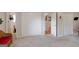 Bedroom with gray carpet, white closets, and a view into an adjacent bathroom at 3359 Villa Ln, Douglasville, GA 30135