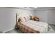Cozy bedroom with neutral walls and carpet, a ceiling fan, and a comfy accent chair at 3359 Villa Ln, Douglasville, GA 30135