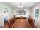 Formal dining room with a large wooden table, seating for ten, and natural light at 3359 Villa Ln, Douglasville, GA 30135