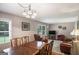 Open concept Living Room and dining room featuring a large window and a ceiling fan with light fixture at 3359 Villa Ln, Douglasville, GA 30135