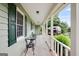 Inviting covered porch with seating area, perfect for relaxing and enjoying the outdoor view at 3359 Villa Ln, Douglasville, GA 30135