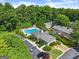 Aerial view showing the pool, clubhouse, parking, landscaping and several apartment buildings in the community at 603 Brighton Pt, Atlanta, GA 30328