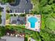 Aerial view of the community pool with lounge chairs, tables, landscaping, and surrounding parking and trees at 603 Brighton Pt, Atlanta, GA 30328