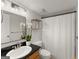 Bathroom featuring a sink with granite countertops, framed mirror, and a shower with a white shower curtain at 603 Brighton Pt, Atlanta, GA 30328