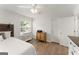 Bright bedroom boasts hardwood floors, a ceiling fan, and natural light from the window at 603 Brighton Pt, Atlanta, GA 30328
