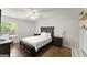 Bright bedroom features a dark wood bed frame, hardwood floors, and a ceiling fan at 603 Brighton Pt, Atlanta, GA 30328