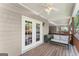 Covered deck with white french doors, outdoor furniture, and a ceiling fan at 603 Brighton Pt, Atlanta, GA 30328