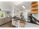The bar in the kitchen features granite counters, wood cabinets, and stainless steel appliances at 603 Brighton Pt, Atlanta, GA 30328