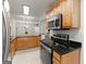 Fully equipped kitchen with sleek appliances, wood cabinetry, granite counters, and an open layout at 603 Brighton Pt, Atlanta, GA 30328