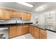 Well-lit kitchen with wooden cabinets, granite counters, and stainless steel appliances with dining area at 603 Brighton Pt, Atlanta, GA 30328