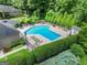 Aerial view showcasing the large community swimming pool and sun deck surrounded by mature trees and landscaping at 603 Brighton Pt, Atlanta, GA 30328
