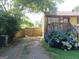Side yard features a wooden gate, driveway and a vibrant hydrangea bush at 649 Mary Ln, Marietta, GA 30062