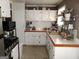 Functional kitchen with white cabinets, tile countertops, and modern appliances at 649 Mary Ln, Marietta, GA 30062