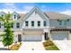 Beautiful townhome featuring a painted brick facade, two-car garage, and manicured landscaping at 1316 Willamette Way, Marietta, GA 30008