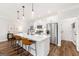Modern kitchen boasts a large island with seating, stainless steel appliances, and hardwood floors at 1316 Willamette Way, Marietta, GA 30008