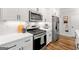 Close-up of a modern kitchen with stainless steel appliances, white cabinets, and quartz countertops at 1316 Willamette Way, Marietta, GA 30008