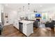 Bright open concept floor plan with modern kitchen island, living room fireplace, and dining area at 1316 Willamette Way, Marietta, GA 30008
