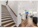 View of the open floor plan featuring a staircase, living room, kitchen, and hardwood floors at 1316 Willamette Way, Marietta, GA 30008