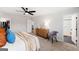 Bright main bedroom featuring a ceiling fan, a wood dresser, and an ensuite bathroom at 1316 Willamette Way, Marietta, GA 30008