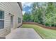 Backyard with a wood fence, patio, lawn, and surrounding trees at 2030 Beyers Landing Dr, Buford, GA 30519