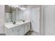 Bathroom featuring double sink vanity with white cabinets, dark fixtures and plank flooring at 2030 Beyers Landing Dr, Buford, GA 30519