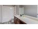 Bathroom features a shower-tub combo, toilet, sink, dark wood vanity, and gray plank flooring at 2030 Beyers Landing Dr, Buford, GA 30519