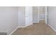 Bedroom has neutral walls and carpeting, with white doors, door hardware and base trim at 2030 Beyers Landing Dr, Buford, GA 30519